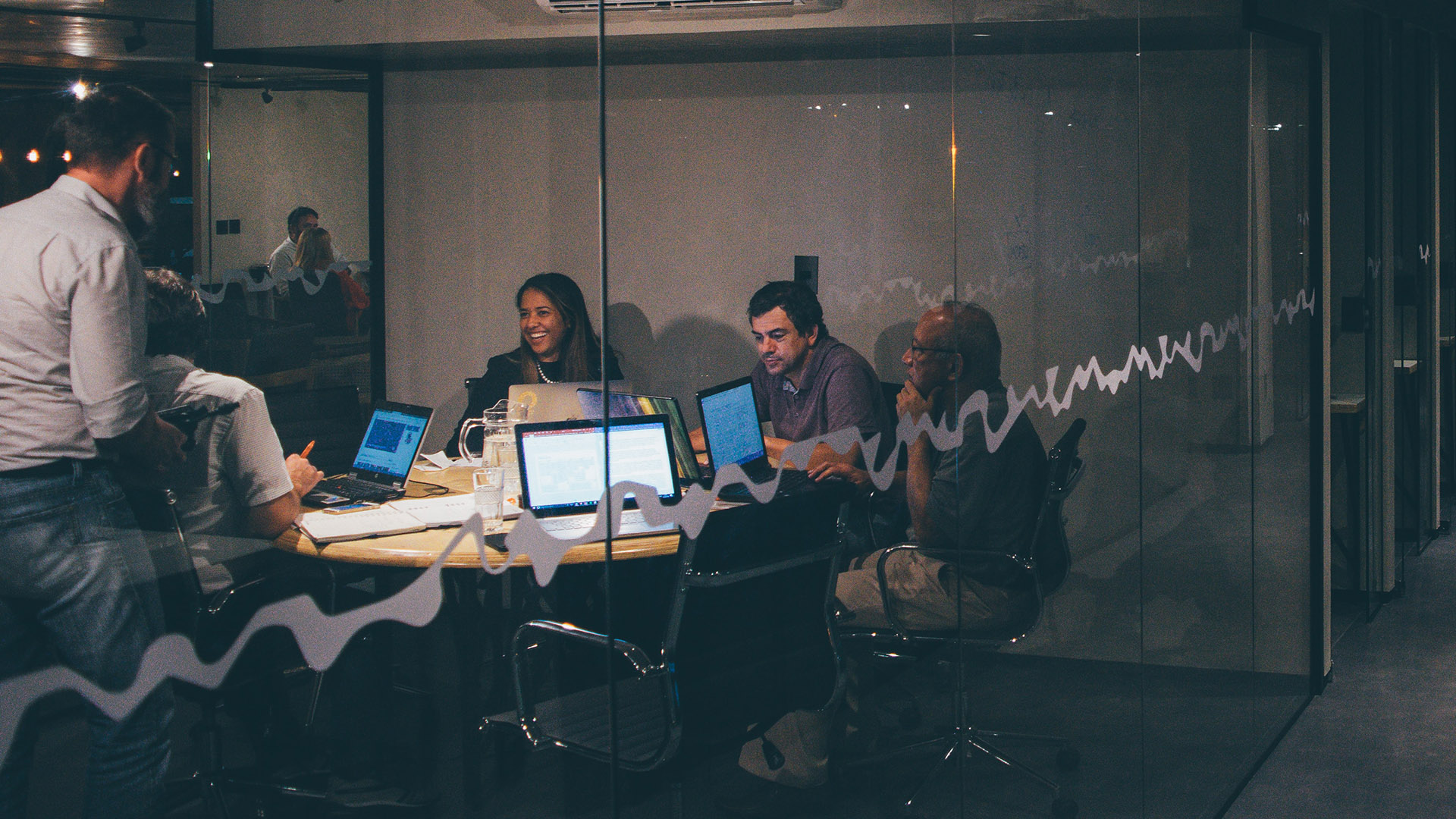 People working on laptops in an office building